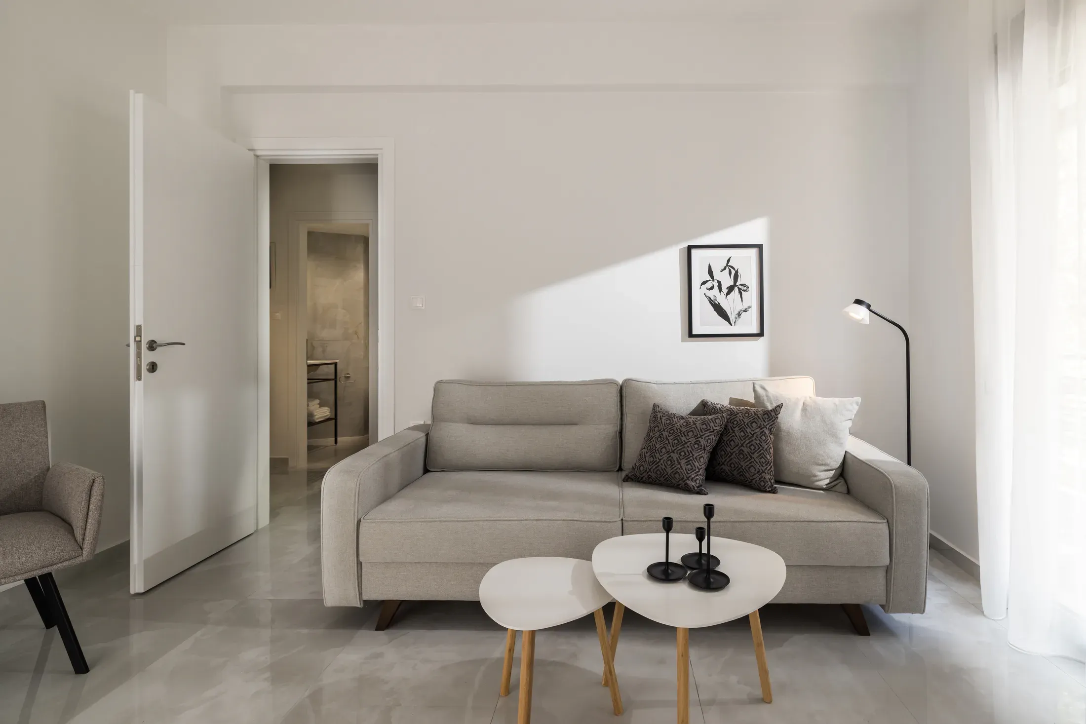 One-bedroom apartment living room with sofa and coffee tables