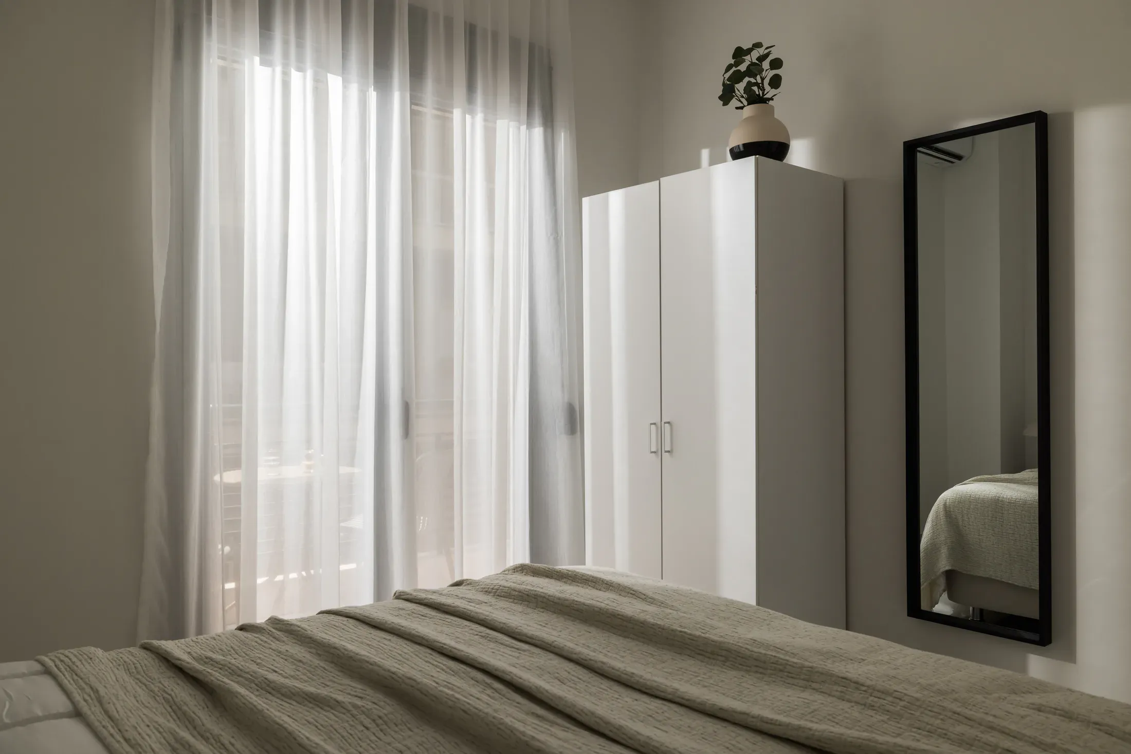 Bedroom with wardrobe and private balcony access