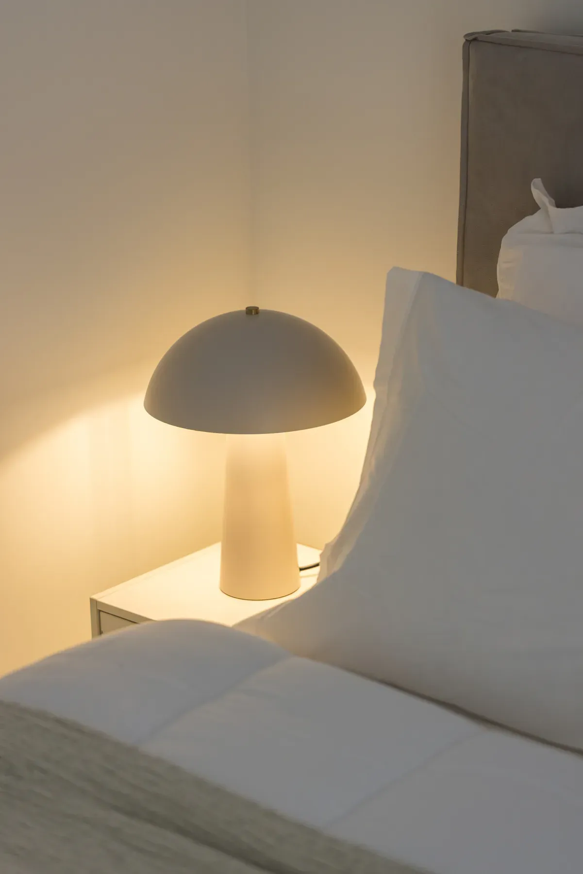Warm bedside lighting in the apartment bedroom