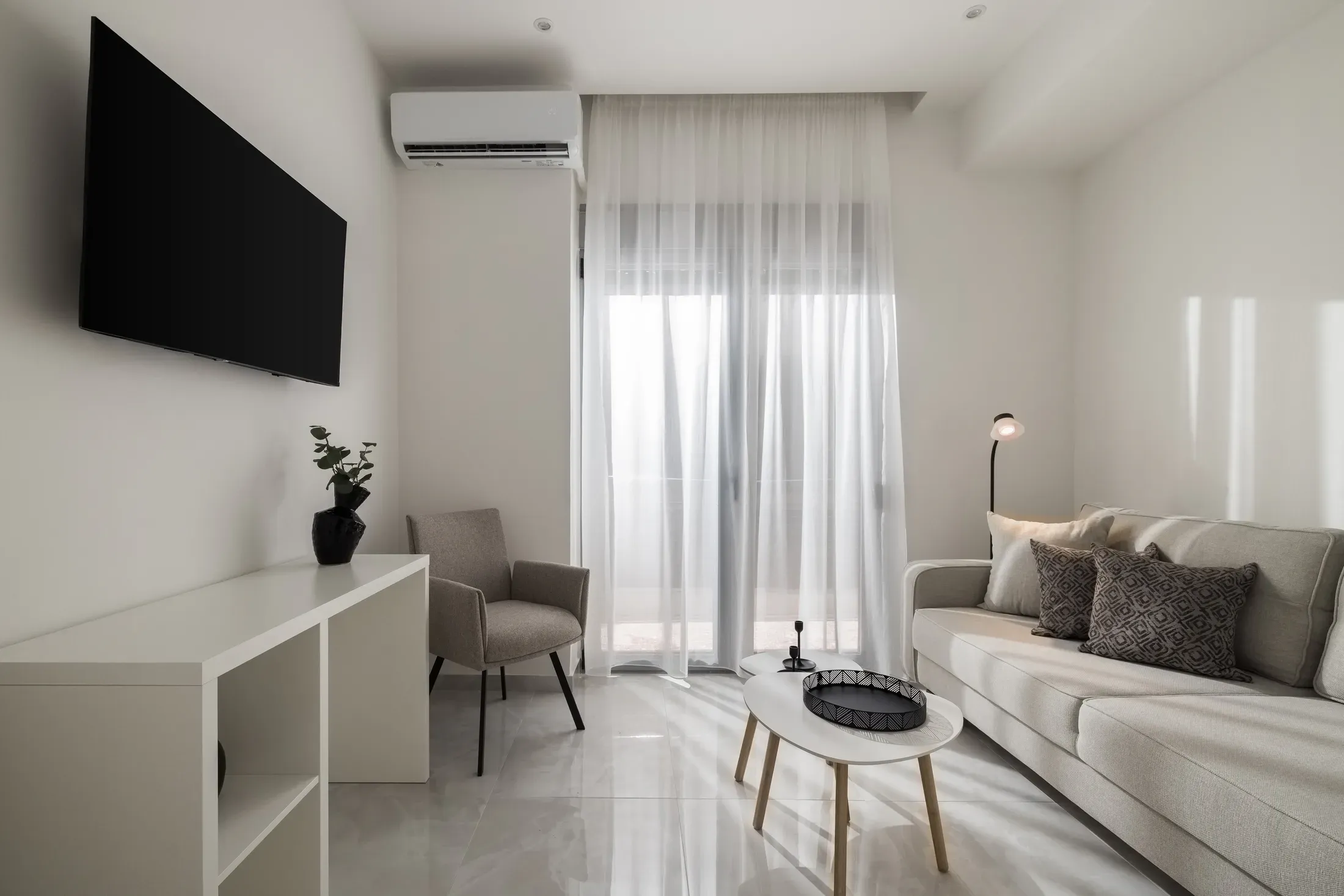 Living room with sofa, Smart TV and dining area