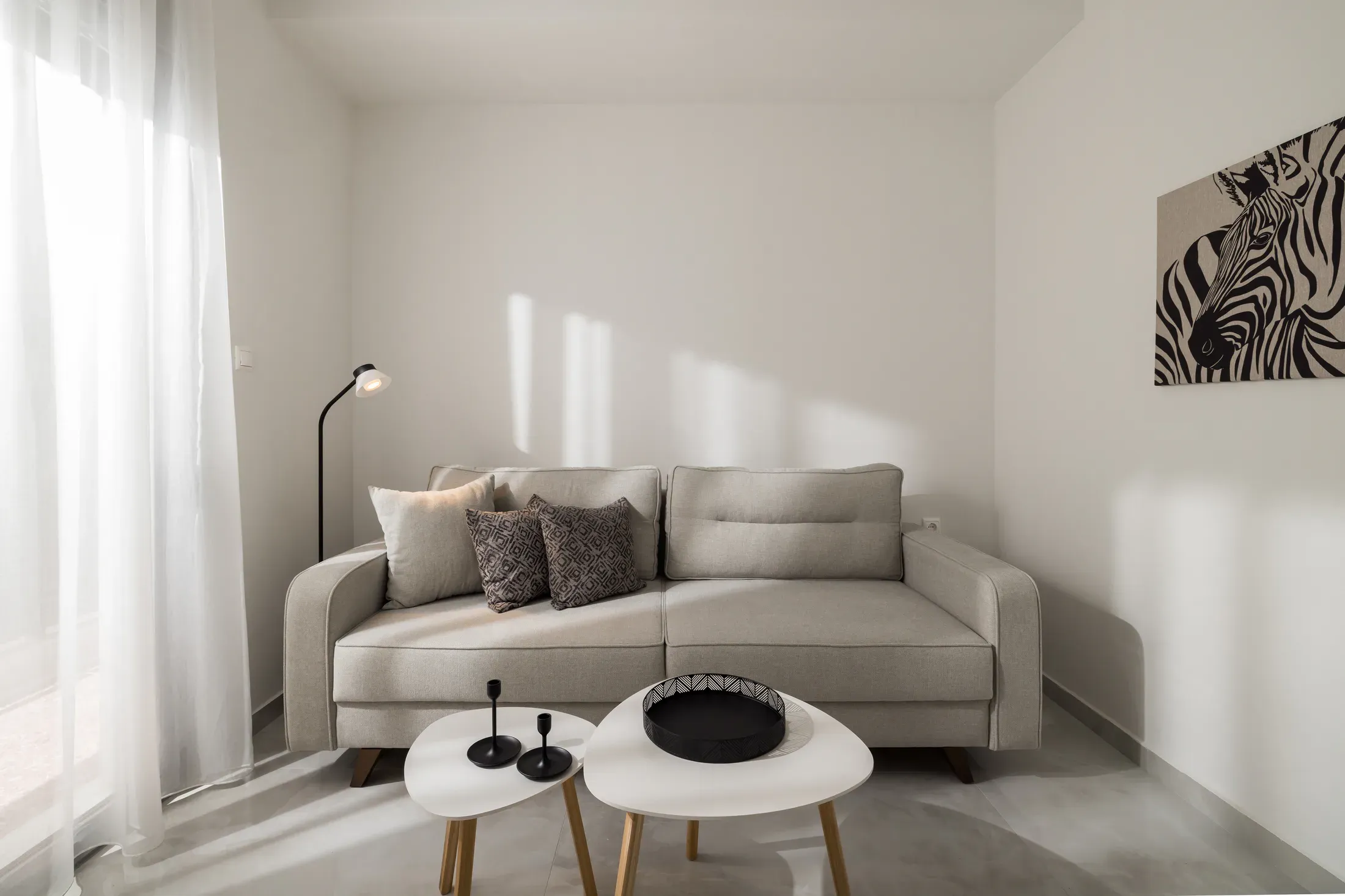 Living area with sofa and round coffee tables
