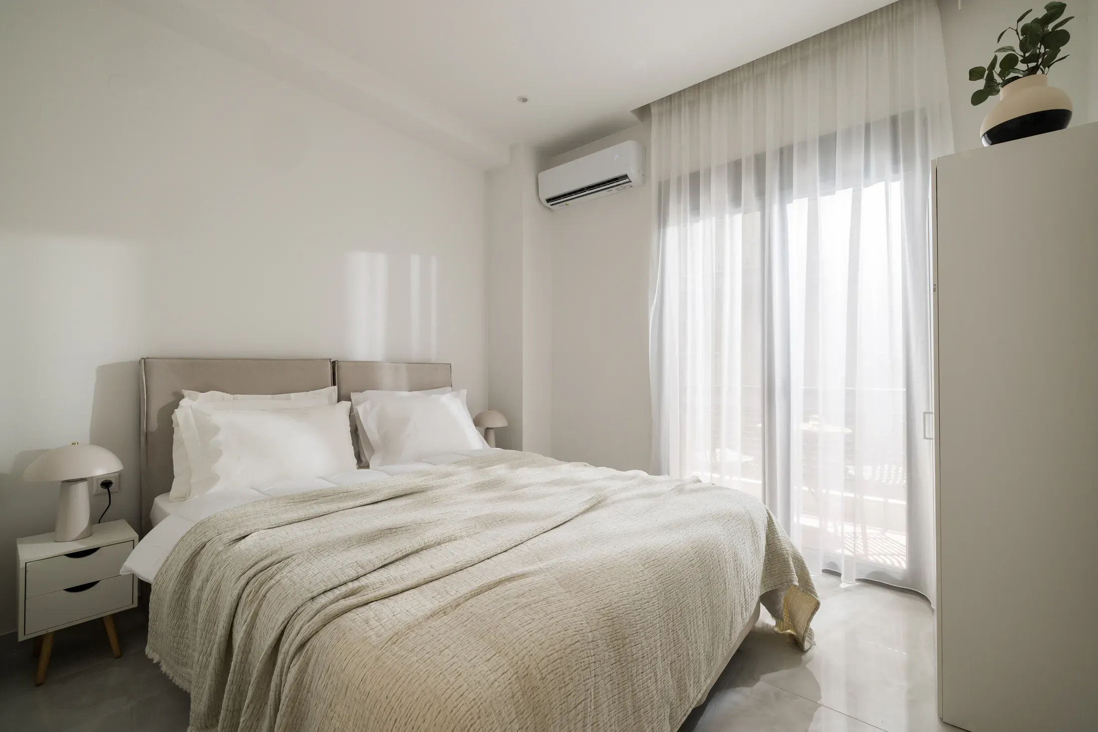 Queen-size bedroom with balcony doors