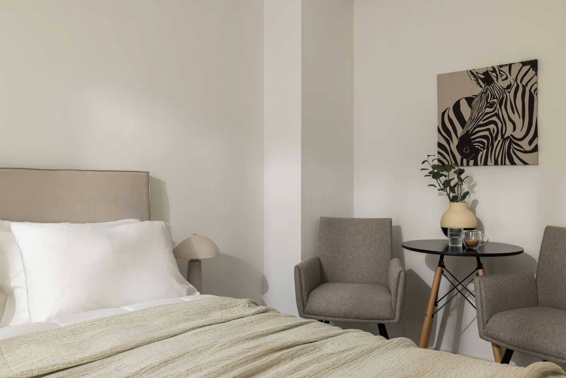 Queen-size bed and seating area in a private bedroom