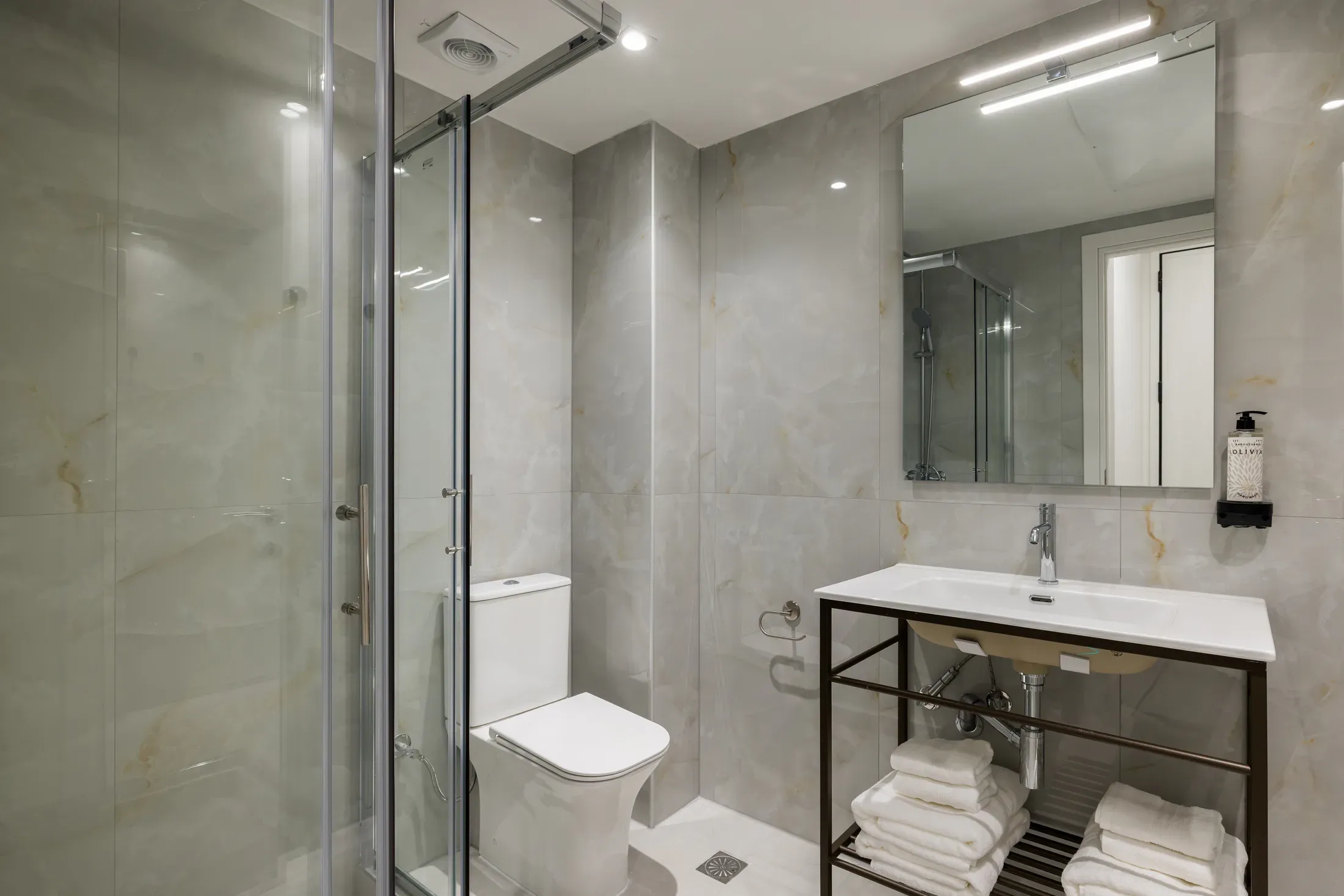 Private bathroom with vanity and walk-in shower