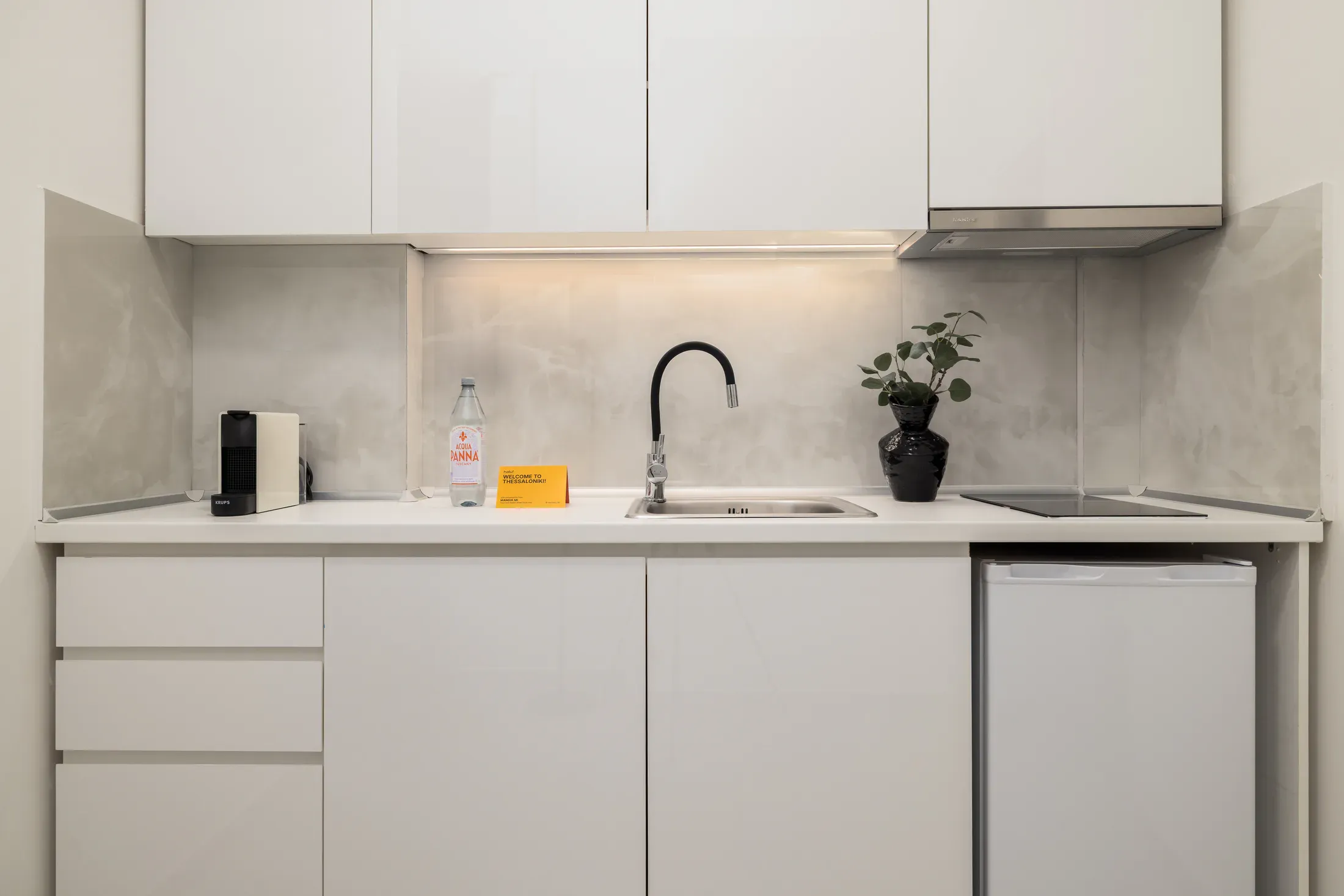 Two-bedroom apartment kitchenette with stovetop and sink