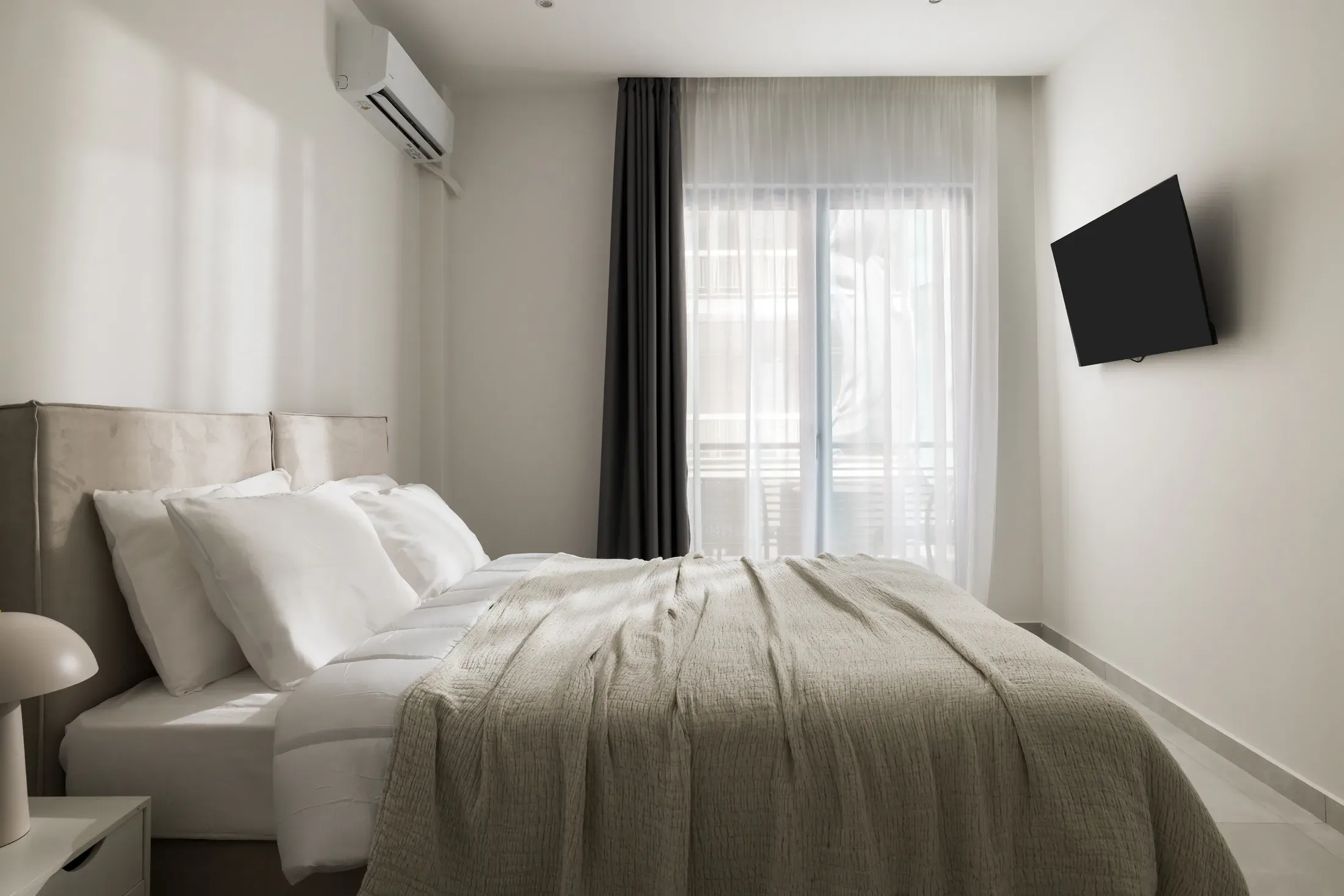 Queen-size bedroom with private balcony access